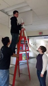 Mankato West students working to retrofit their school's lighting with more energy-efficient bulbs